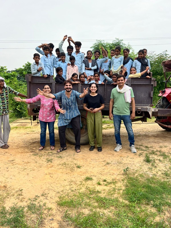 Sanya Ghai and field team with rural school children during community outreach in Rajasthan